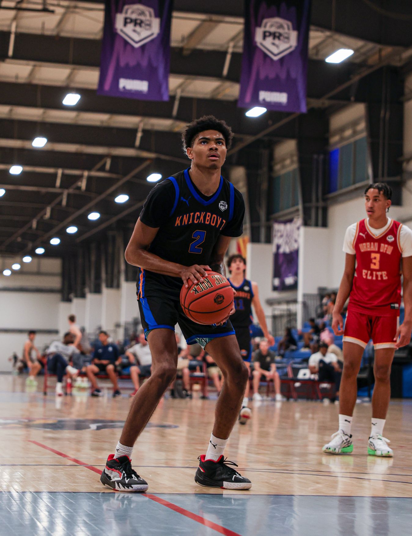 Two young athletes play basketball