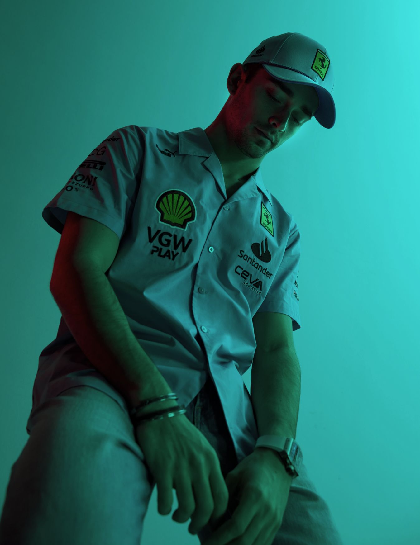 Charles Leclerc poses in Ferrari clothing.