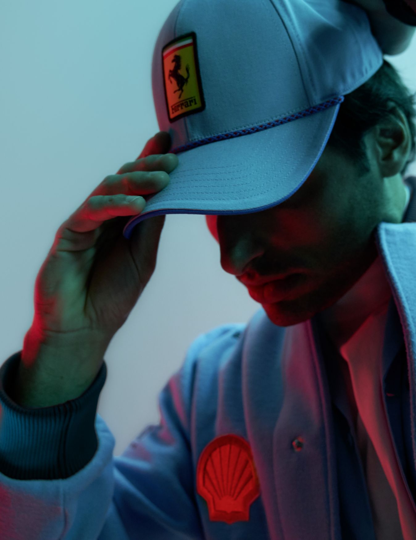 Portrait of Charles Leclerc in Ferrari gear.