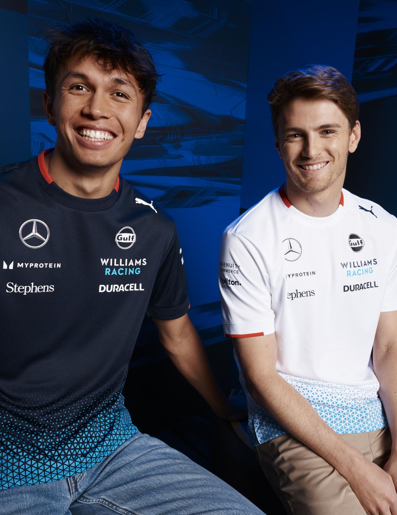 Alexander Albon and Logan Sargeant sitting next to each other.