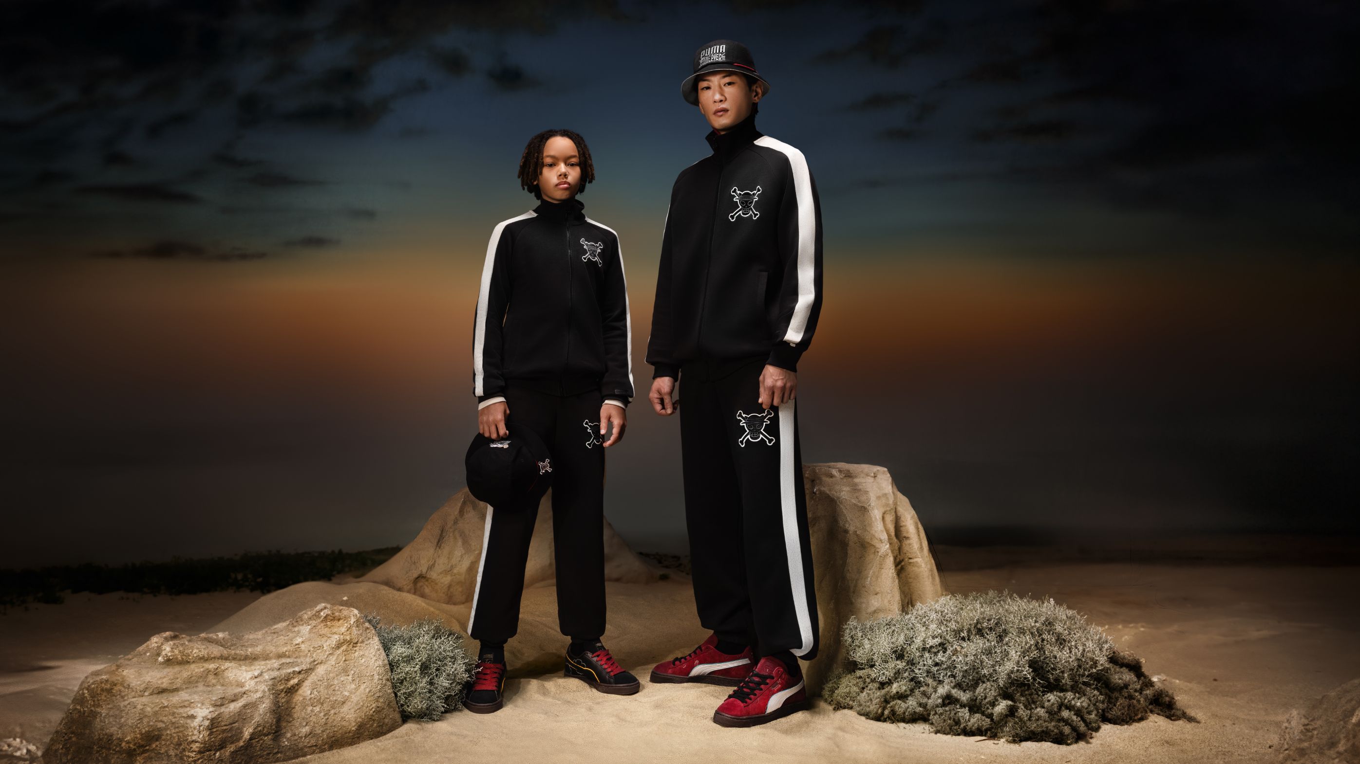 Kids standing in the dawning dessert, sporting tracksuits of the PUMA x OnePiece collection.