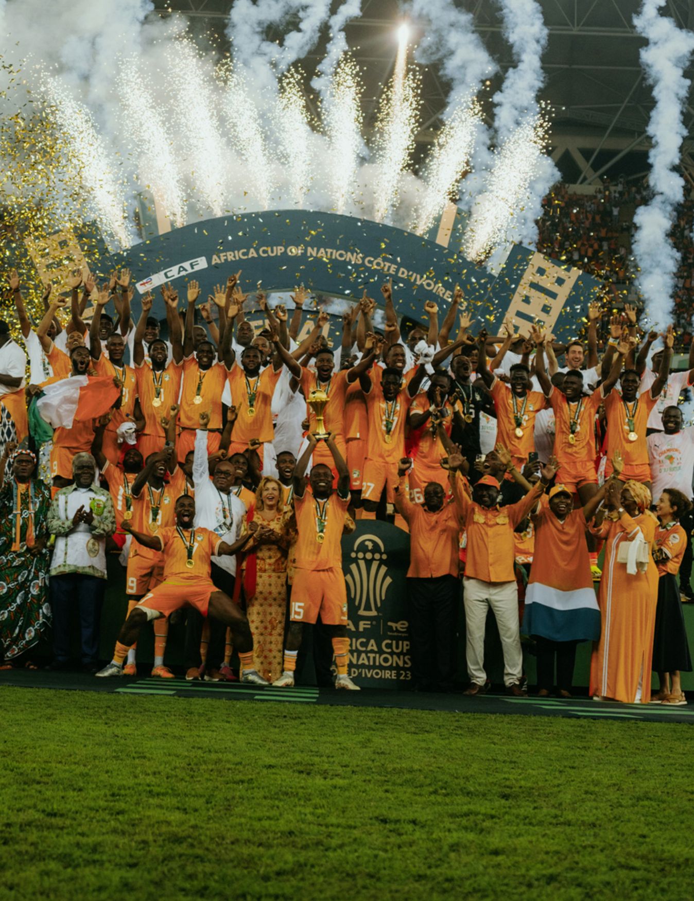 The Ivory Coast team cheers accompanied by fireworks during the African Cup of Nations celebrations.